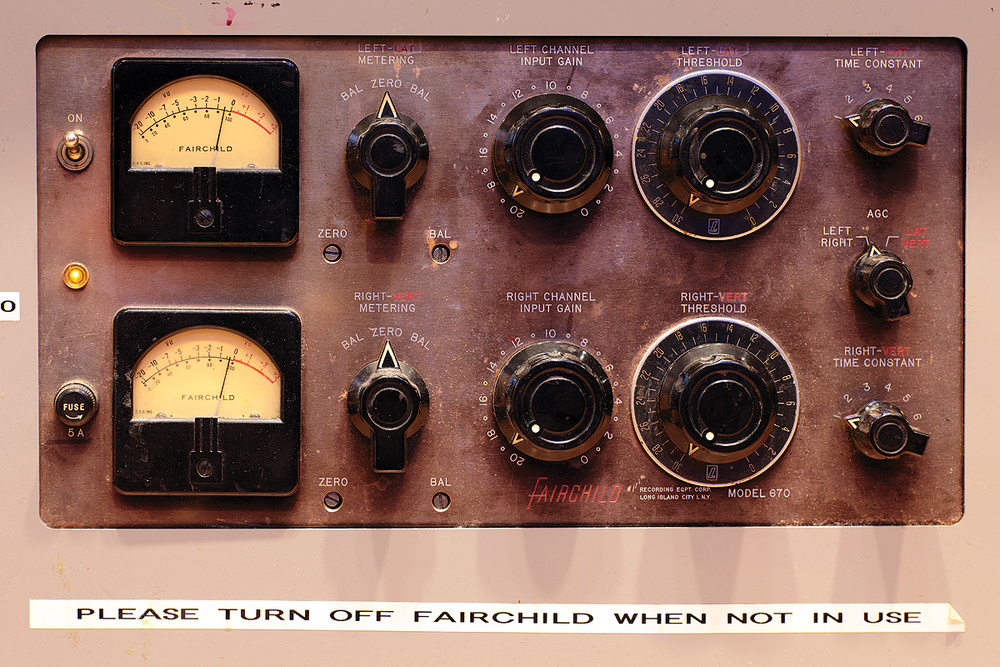An old fashioned compressor with two sets of dials and knobs, one for the left signal and another for the right. There is a label stuck on the bottom that says 'Please turn off Fairchild when not in use'.