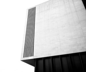 Grey scale photo of a minimalist concrete building.